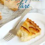 a pinterest image showing a slice of apple frangipane tart with text overlay
