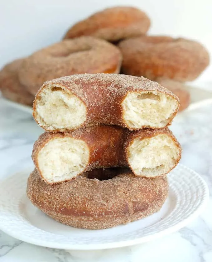 A broken in half sourdough donut showing the inside crumb