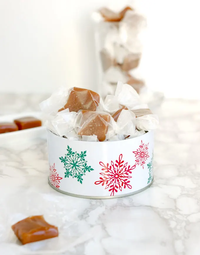 wrapped candies in a christmas tin.