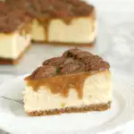 a slice of bourbon butterscotch cheesecake with pecans