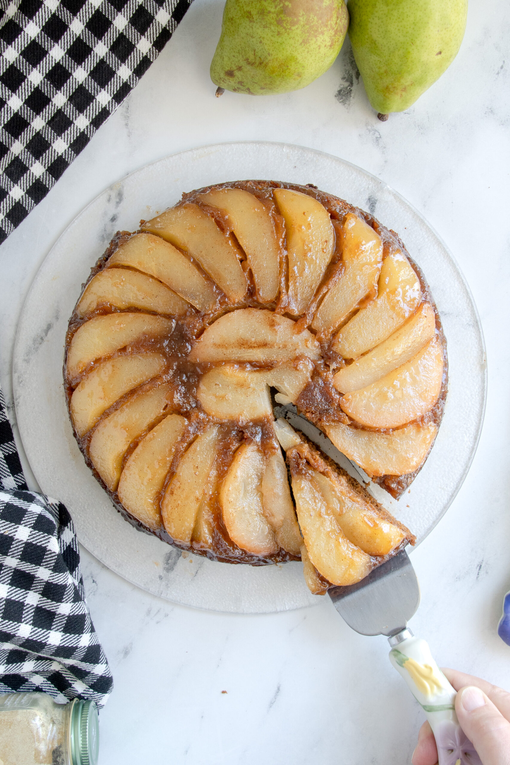 a pear upside down cake on a white table.