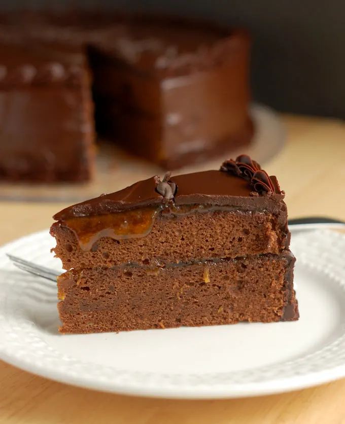 a slice of sacher torte on a white plate