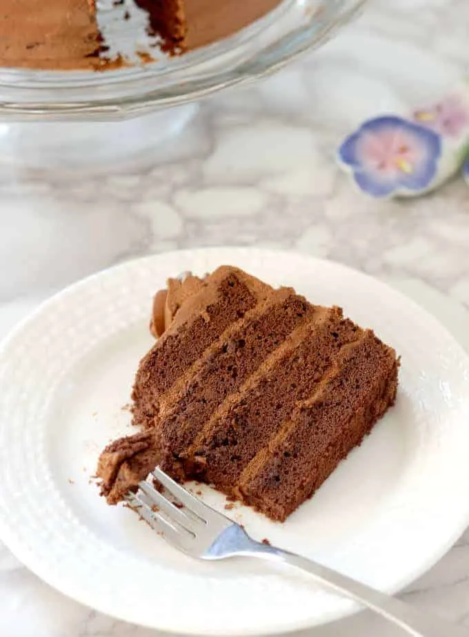 a partially eaten slice of chocolate genoise filled with chocolate cream