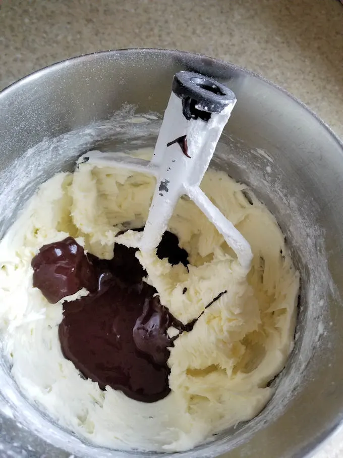 whipped butter and sugar with chocolate in a mixing bowl