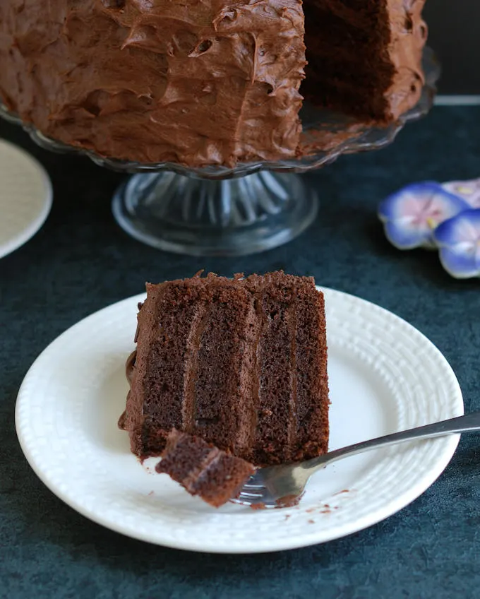 a slice of old fashioned chocolate cake on a plate with a fork