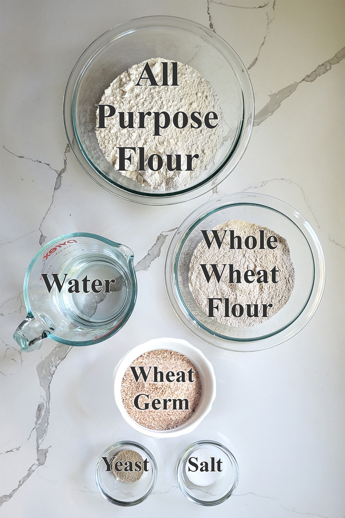 ingredients for whole grain low knead bread in glass bowls.