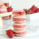 a stack of strawberry Rose macarons