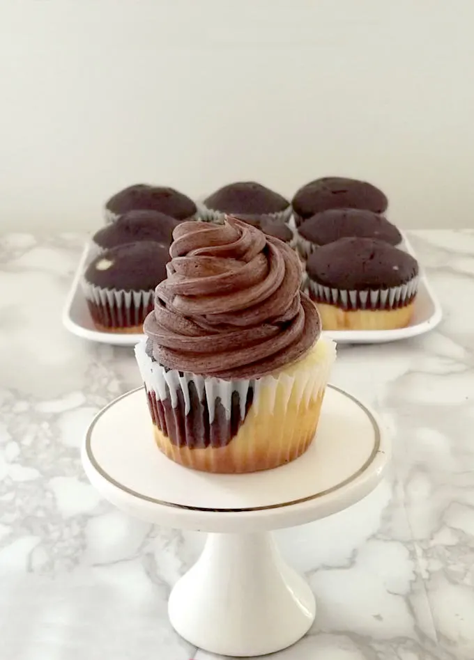 marble cupcake with chocolate frosting on a mini cake stand