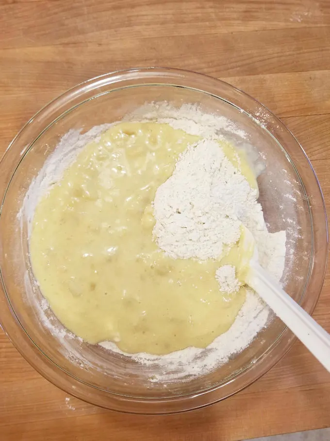 mixing wet and dry ingredients for making chocolate chunk banana bread