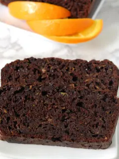 chocolate Zucchini bread slices on a white plate.