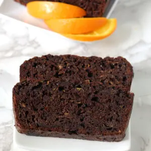 chocolate Zucchini bread slices on a white plate.