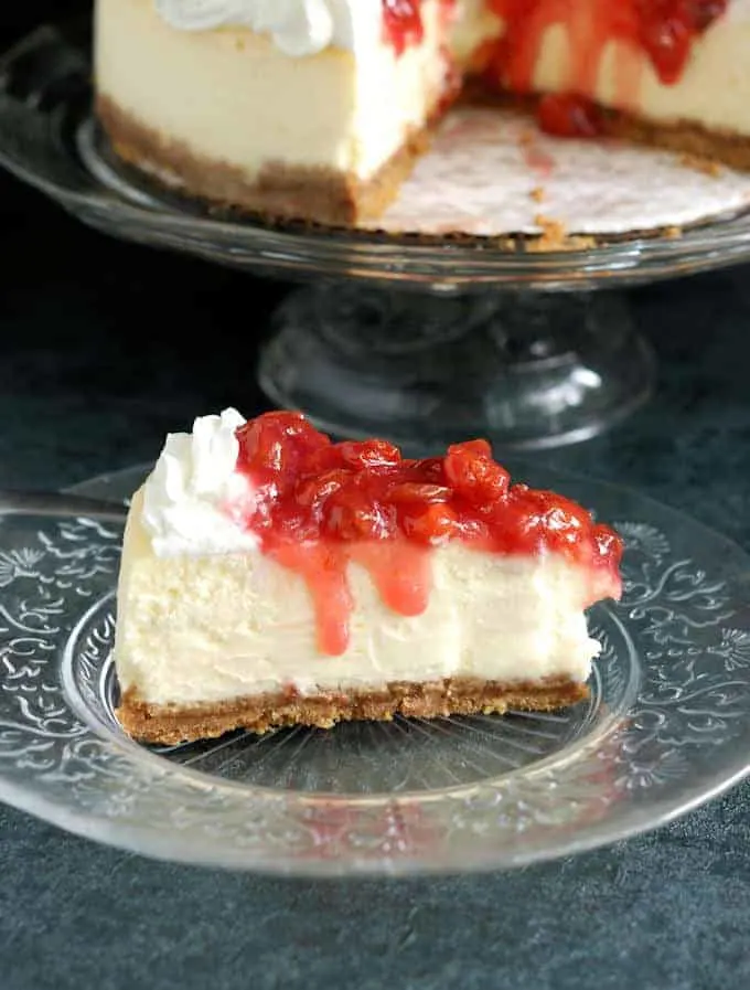 a slice of New York Cheesecake with sour cherry topping