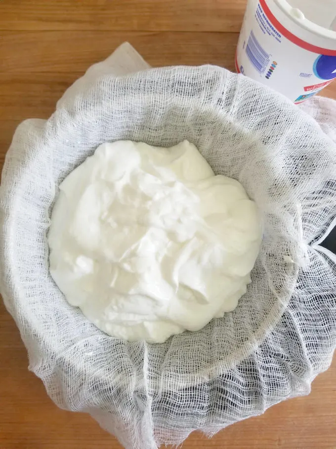 yogurt in cheesecloth over a bowl