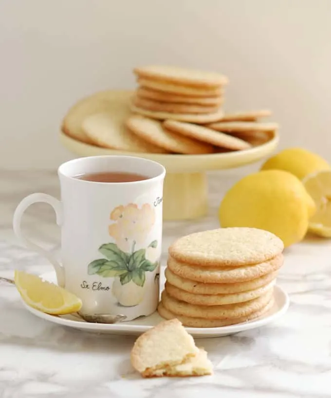 lemon thin cookies and a cup of tea on a table