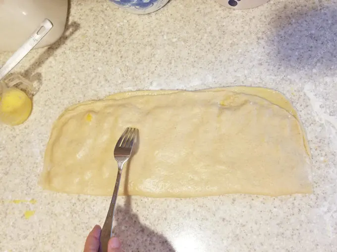 dough folded over peach chunks