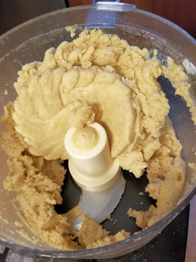 Make the crust for apple walnut linzer tart in a food processor.