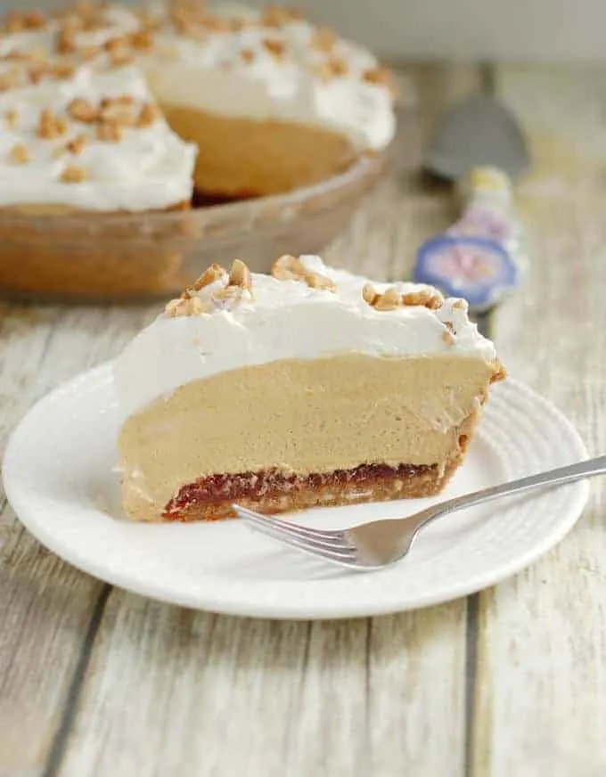 A slice of peanut butter mousse pie with hot pepper jelly on a plate