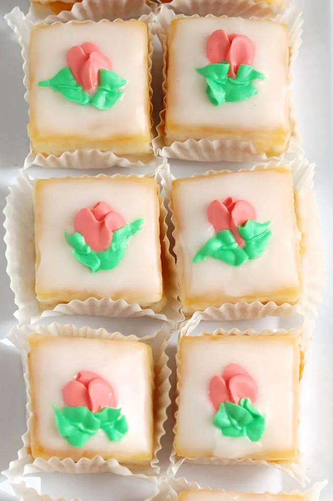 a tray of classic almond petit fours with fondant icing