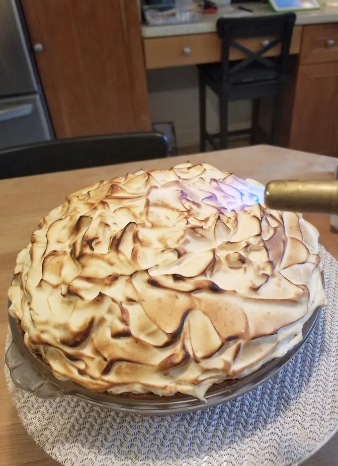 Toasted brown sugar meringue on a pumpkin mousse pie