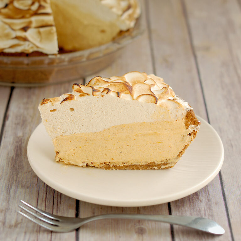 a slice of pumpkin mousse pie on a white plate.