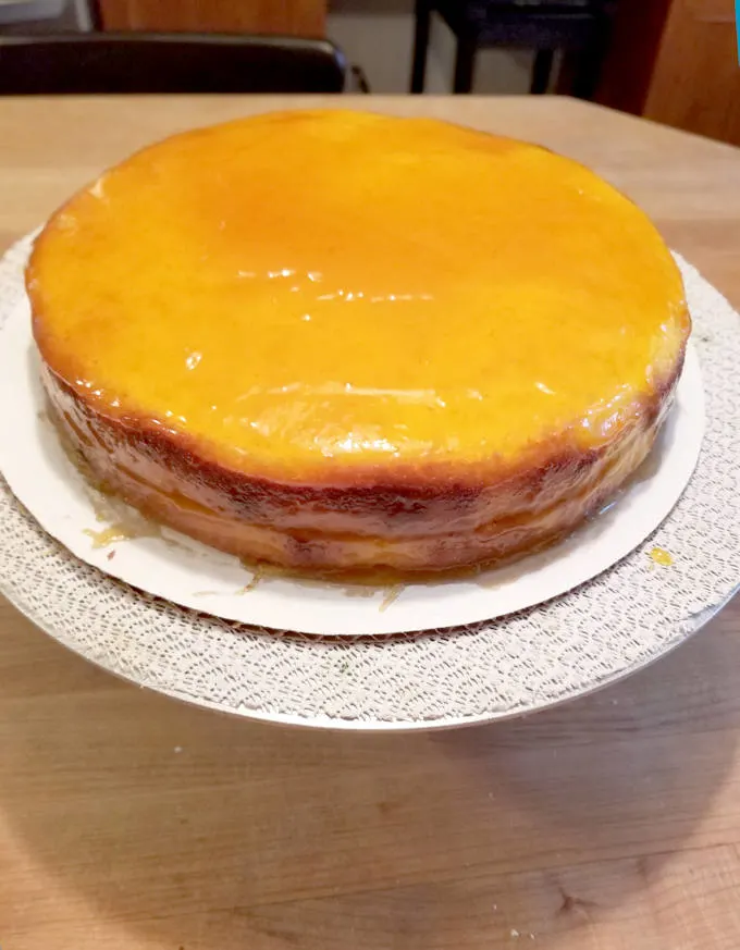 white chocolate cake ice wit apricot preserves on a cake turntable.