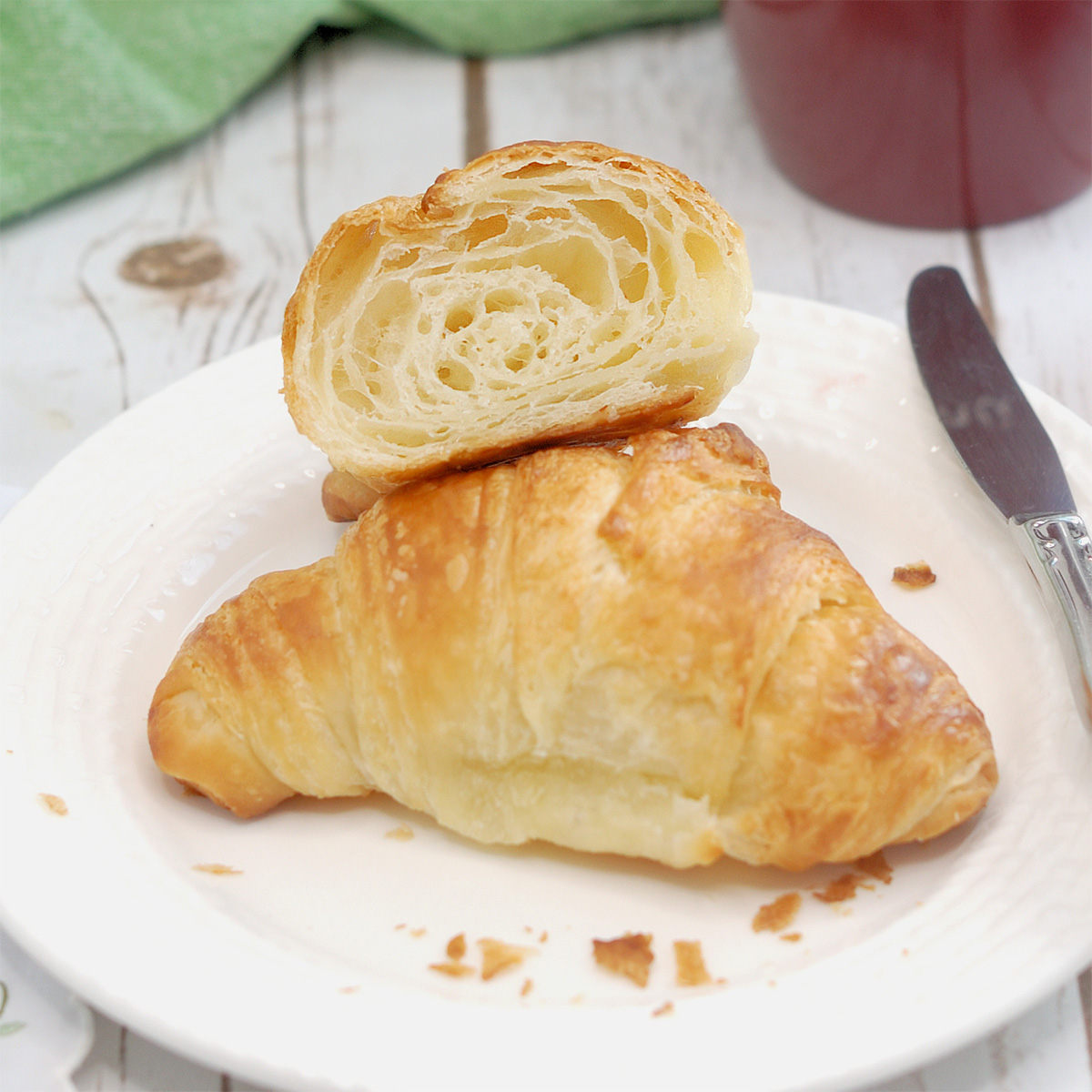 a croissant on a white plate.