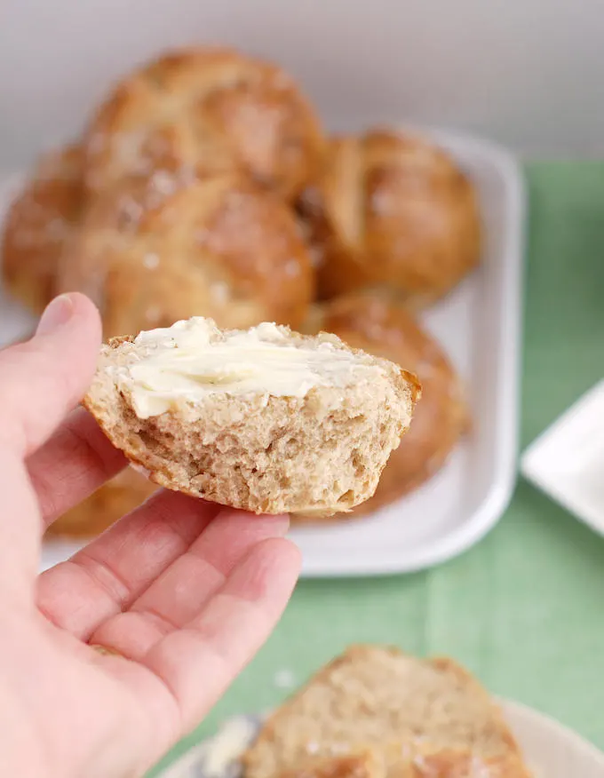 a piece of a malt and rye pretzel roll with butter