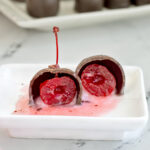 a cherry cordial candy on a white plate.