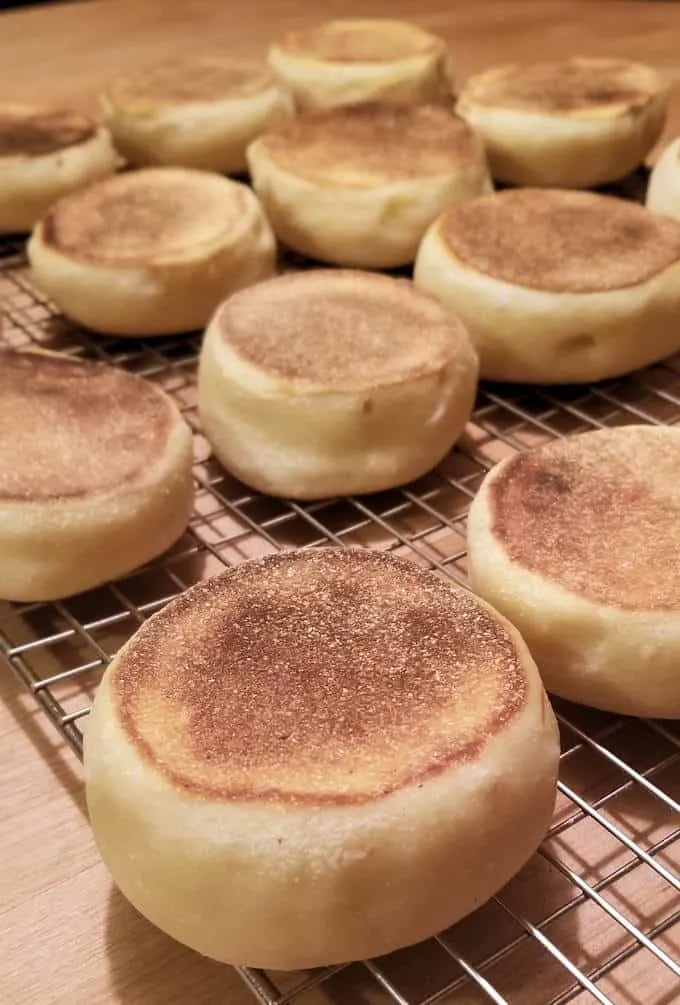 sourdough english muffins on a cooling rack