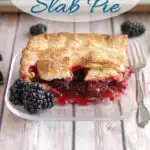 a pinterest image showing a slice of blackberry slab pie on a glass plate