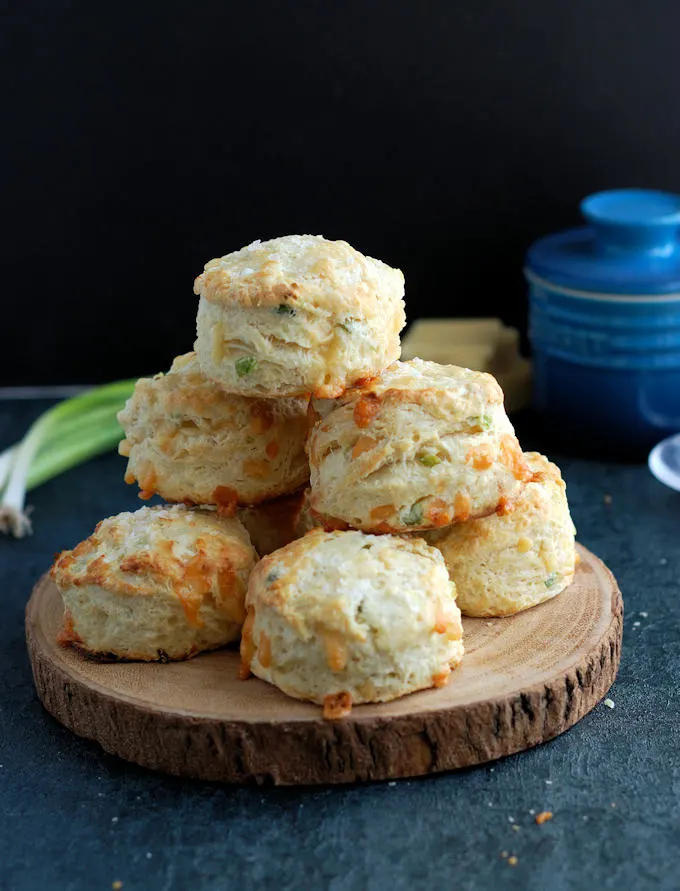 A tray of freshly baked Irish Cheddar Cheese Scones against a dark background.