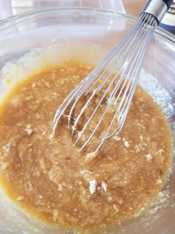 Malted milk powder being whisked into blondie batter.