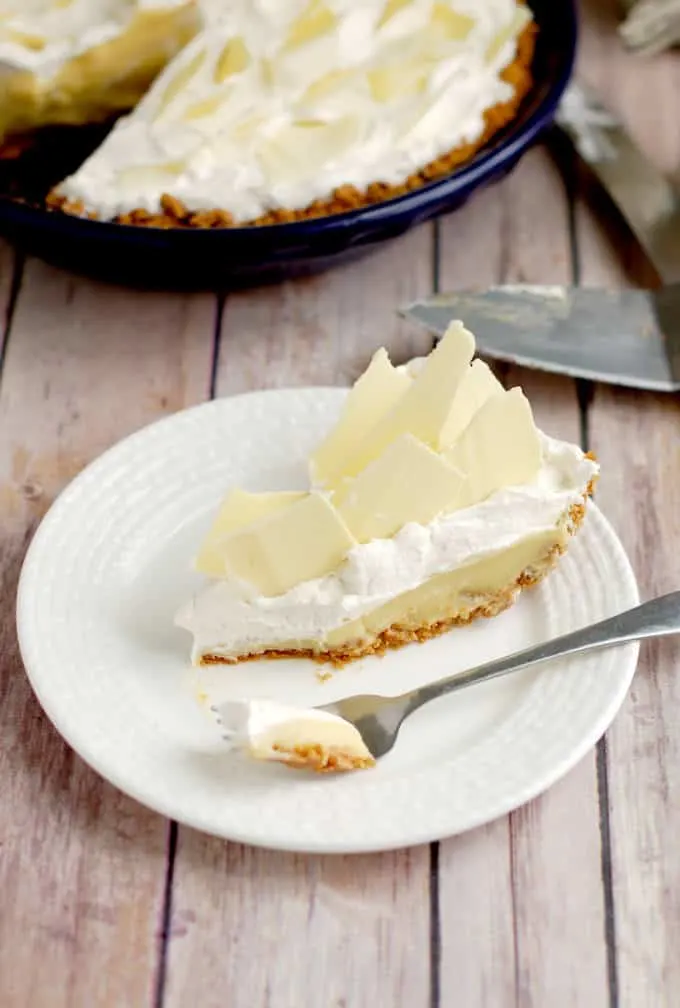 a slice of malted milk cream pie on a white plate with a fork