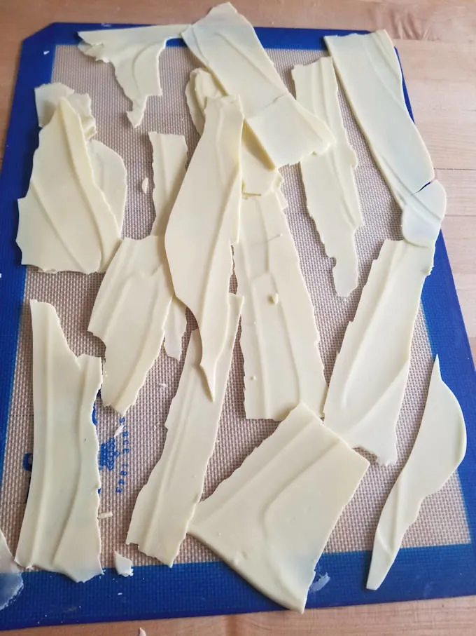 shards of white chocolate on a silicone baking mat