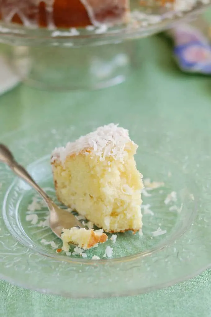 a slice of coconut pound cake on a glass plate.