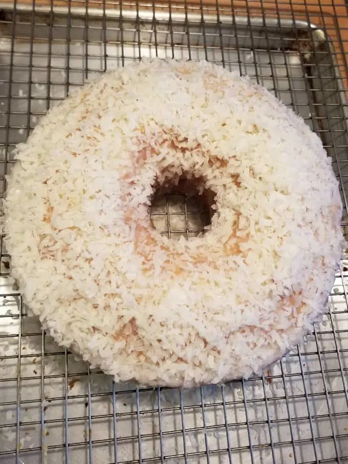 a coconut cake on a cooling rack