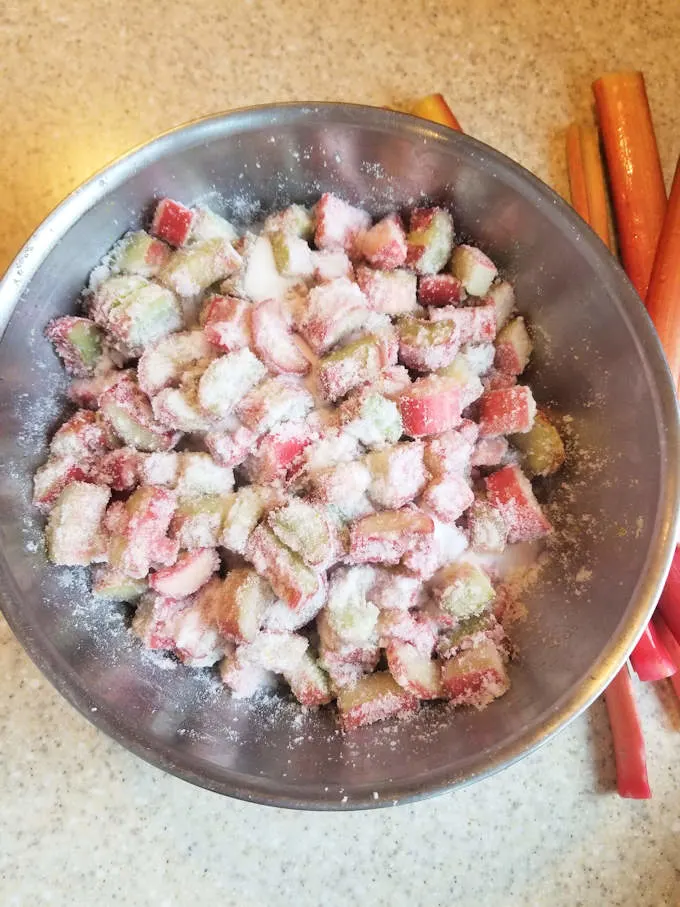 A bowl of chopped rhubarb with sugar.