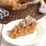 a slice of rhubarb crumb pie on a white plate