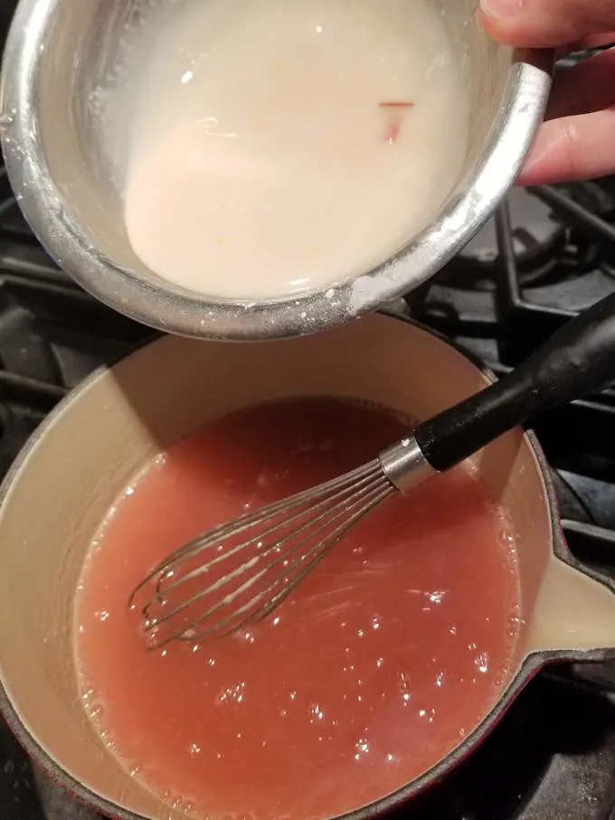 a pot of boiling rhubarb juice and a bowl with corn starch slurry