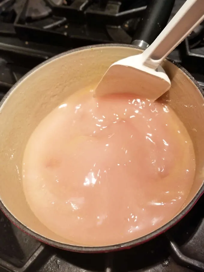 a pot of boiling rhubarb juice thickened with cornstarch