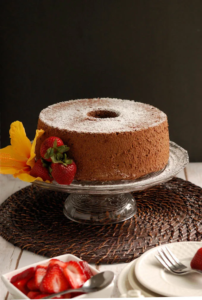 a chocolate angel food cake on a cake stand