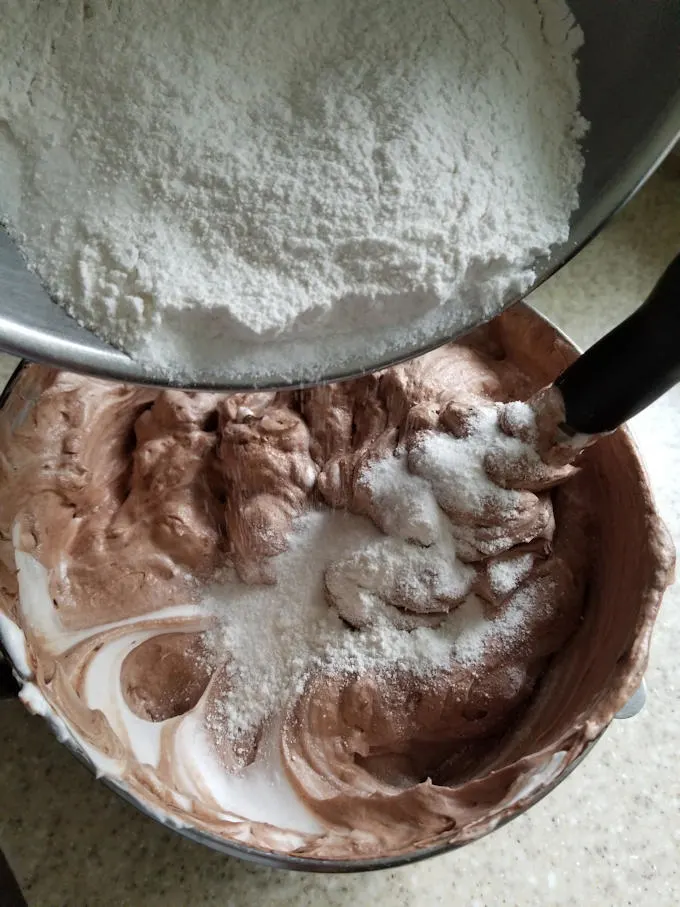 Folding flower into chocolate meringue