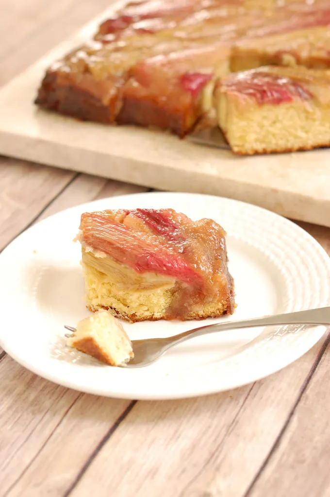 a slice of rhubarb upside down cake on a plate with a fork