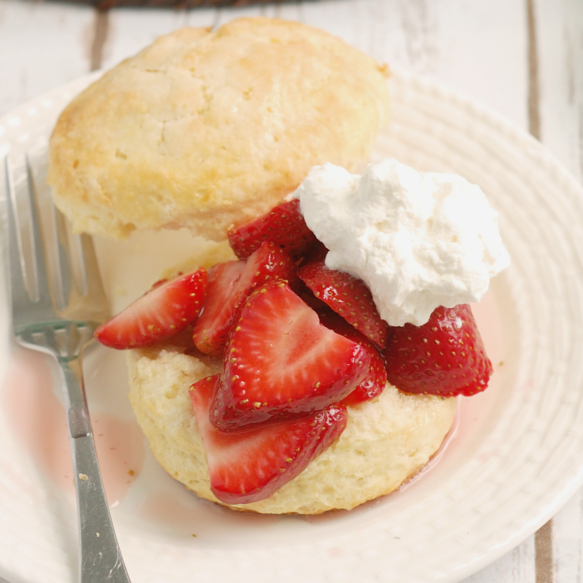 a strawberry shortcake on a white plate.