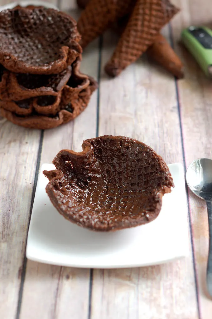 a chocolate coated waffle bowl on a plate