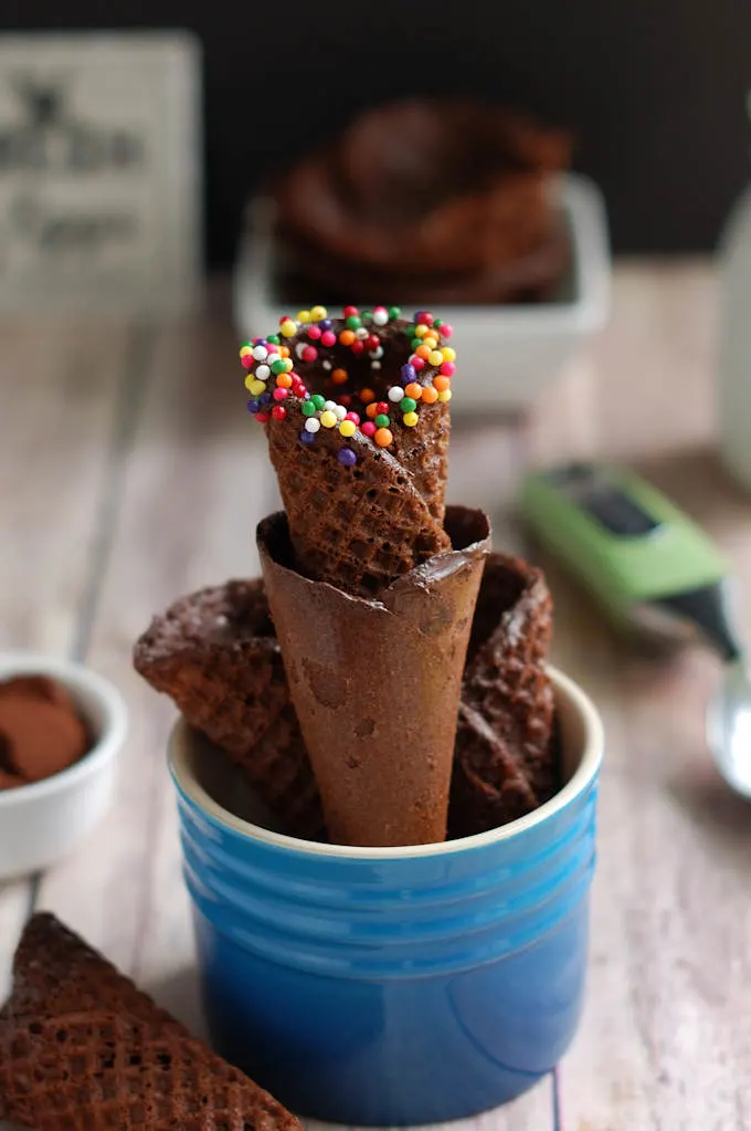a stack of chocolate waffle cones in a container
