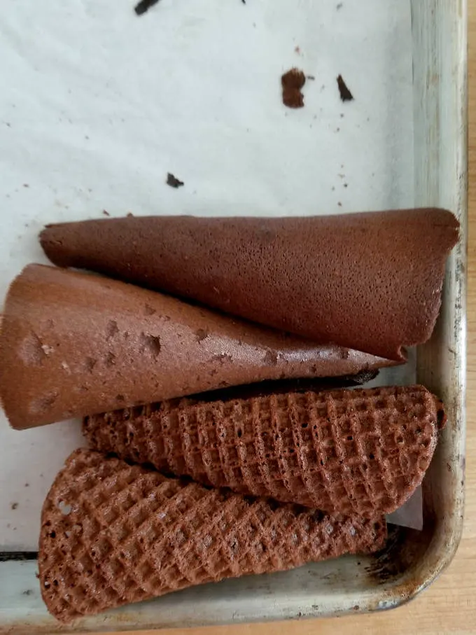 chocolate waffle cones cooling on a tray