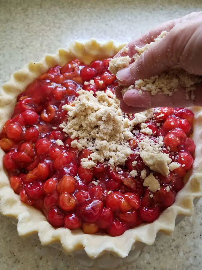 Adding crumb topping to a cherry pie