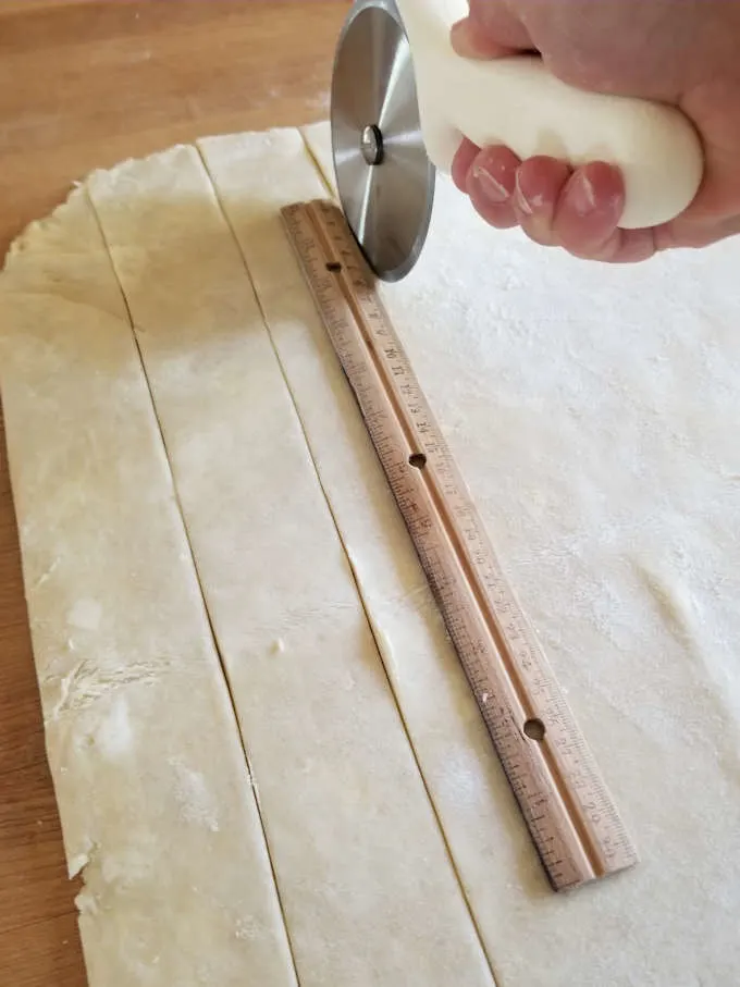 cutting pie dough into strips for lattice pie crust