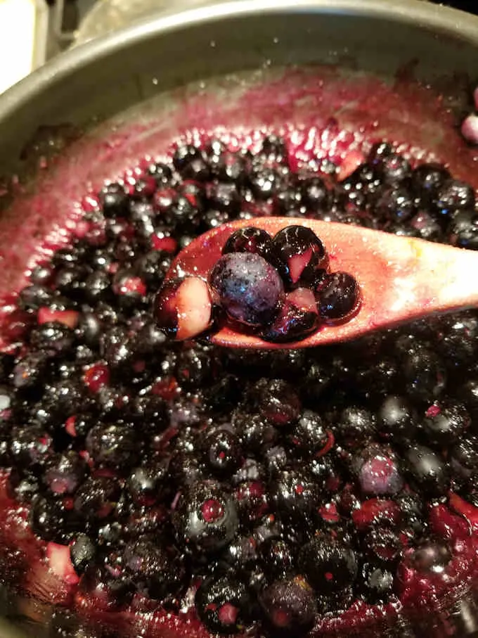 a pot of blueberries cooking on the stove